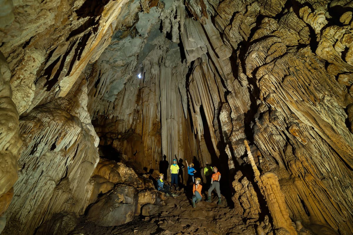 An expedition group exploring a cave with Oxalis Adventure